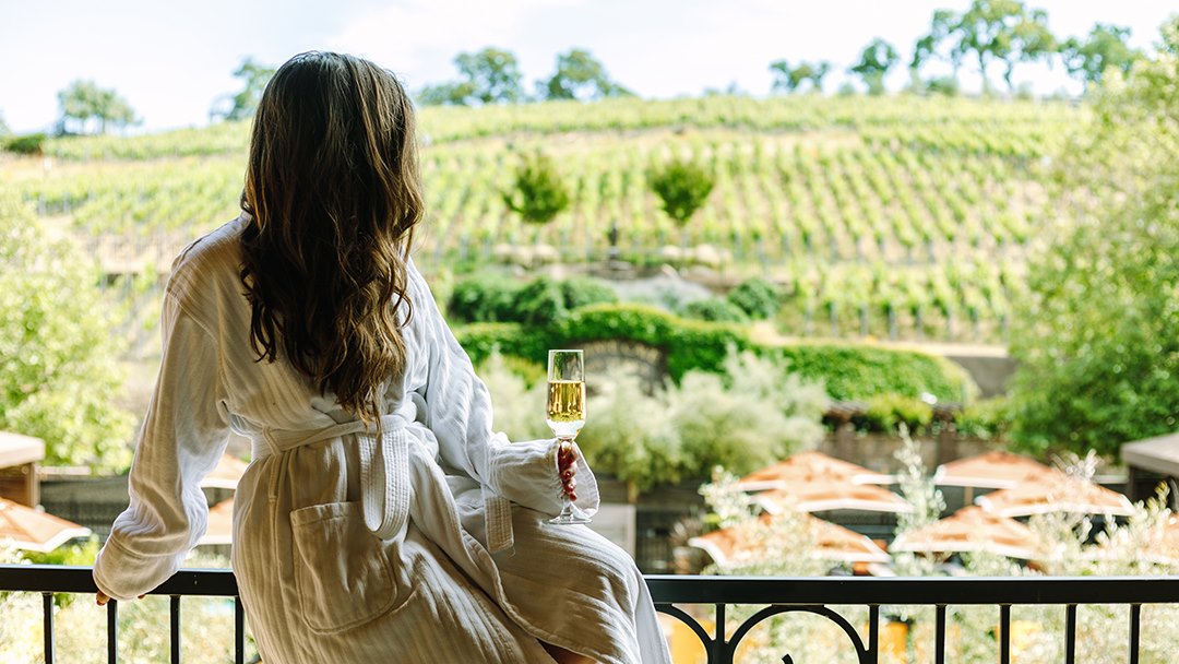 Woman in bathrobe enjoying wine for Mother's Day in Napa
