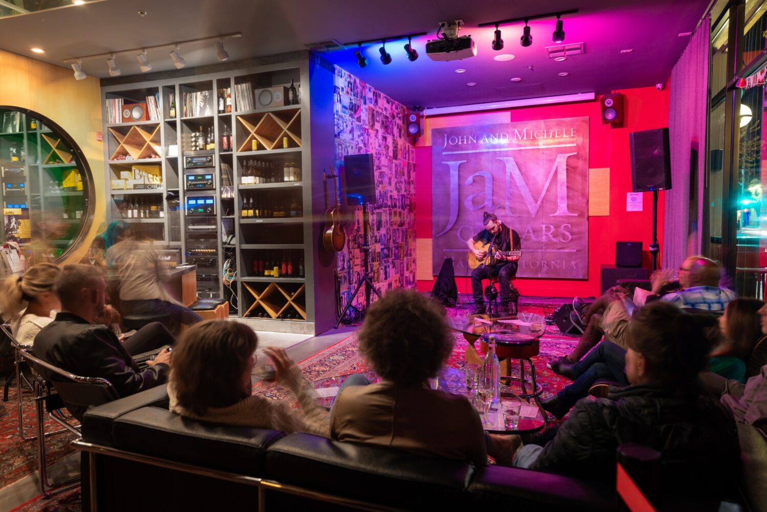 Solo guitarist performs in front of seated crowd during JaMSessions at JaM Cellars music venue in Napa