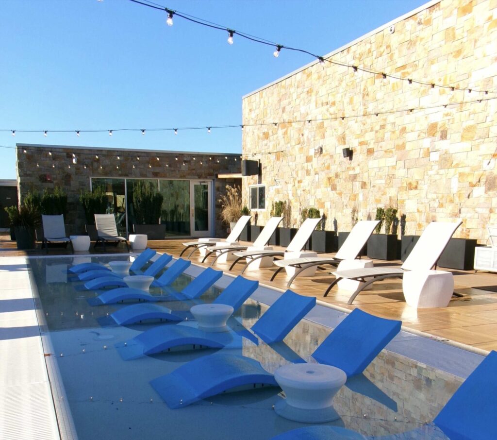 Outdoor rooftop lounge at Archer Hotel Napa with lounge chairs and city views.